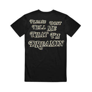 image of the back of a black tee shirt on a white background. back of tee says please don't tell me that I'm dreamin'