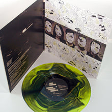 Load image into Gallery viewer, A green and black marbled vinyl LP by Mayday Parade sits before an open album cover showcasing abstract art, song lyrics, and black-and-white faces partially hidden by collage details.