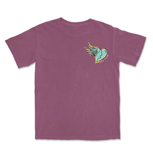 image of the front of a berry colored tee shirt on a white background. the front of the tee has a small chest print on the right of a teal broken heart with an angel wing. curved below the wing in cursive says mayday parade.