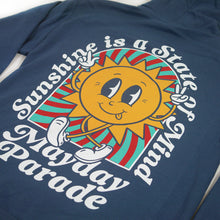 Load image into Gallery viewer, close up, angled image of the back of an indigo colored pullover hoodie on a white background. the back of the hoodie has a full back print of a sun with a face, with legs and the arms in the air. arched around the sun says sunshine is a state of mind and across the bottom says mayday parade
