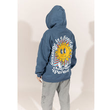 Load image into Gallery viewer, image of a woman wearing an indigo pullover hoodie. image of the back of an indigo colored pullover hoodie on a white background. the back of the hoodie has a full back print of a sun with a face, with legs and the arms in the air. arched around the sun says sunshine is a state of mind and across the bottom says mayday parade
