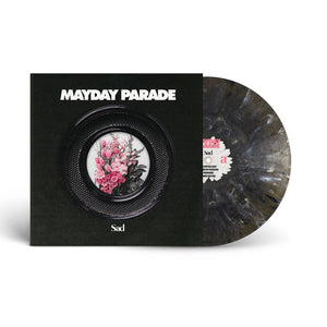 A limited edition Mayday Parade vinyl in a black and gray marbled Onyx Variant is partly out of its sleeve. The sleeve shows “Mayday Parade” above a black plate with a pink floral bouquet and the word “Sad” below.