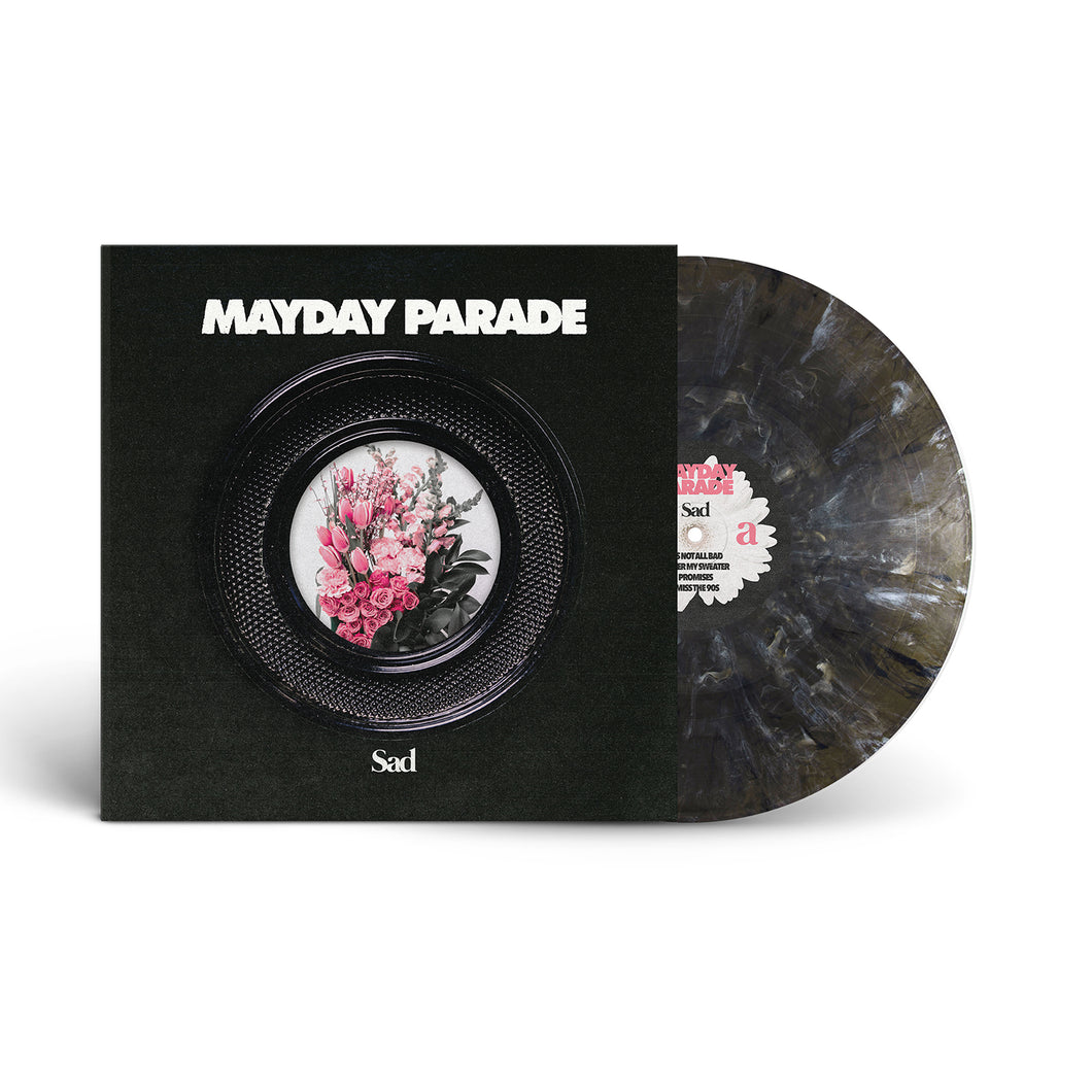 A limited edition Mayday Parade vinyl in a black and gray marbled Onyx Variant is partly out of its sleeve. The sleeve shows “Mayday Parade” above a black plate with a pink floral bouquet and the word “Sad” below.