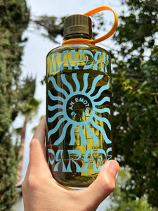 image of a green naglene water bottle being held up outside. across the front of the bottle in blue says mayday parade. in the center says is an emotion with a sun image surrounding it