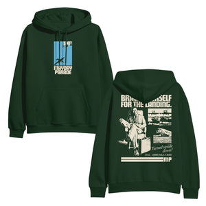 image of the front and back of a forest green pullover hoodie on a white background. front is on the left and has a center chest print of a blue rectangle with an airplane. below says mayday parade. the back is on the right and has an image of a man sitting with a suitcase and a collage of airplanes. across the shoulders says brace yourself for the landing. on the bottom right says Turned upside down? dial 1 800 m l s c r s h