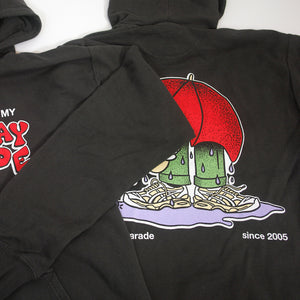 image of the back of a railroad grey pullover hoodie. hoodie has a full print of someone with a large red umbrella standing in a rain puddle