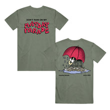 Load image into Gallery viewer, image of the front and back of a moss green tee shirt. front is on the left and has a center chest print that says don&#39;t rain on my mayday parade. back is on the right and has a full body print of a person with a big red umbrella standing in a rain puddle
