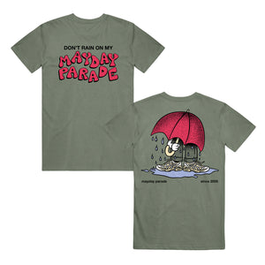 image of the front and back of a moss green tee shirt. front is on the left and has a center chest print that says don't rain on my mayday parade. back is on the right and has a full body print of a person with a big red umbrella standing in a rain puddle