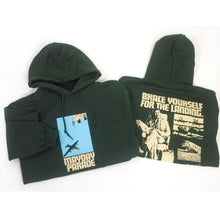 Load image into Gallery viewer, image of the front and back of a folded forest green pullover hoodie on a white background. front is on the left and has a center chest print of a blue rectangle with an airplane. below says mayday parade. the back is on the right and has an image of a man sitting with a suitcase and a collage of airplanes. across the shoulders says brace yourself for the landing. on the bottom right says Turned upside down? dial 1 800 m l s c r s h
