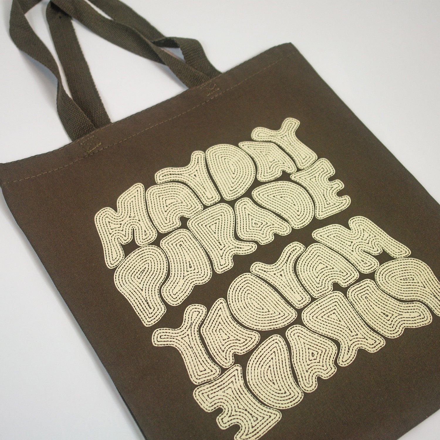 image of an army green tote bag. tote that says mayday parade. it also says it again upside down.