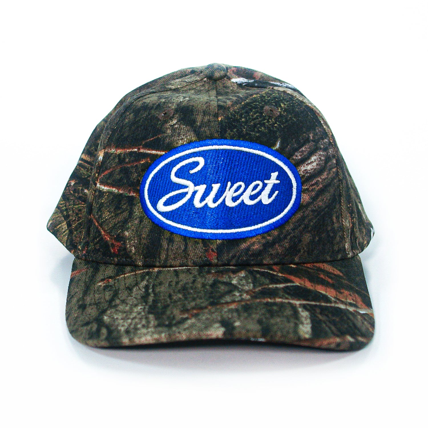 A Mayday Parade camouflage baseball cap features a blue oval patch on the front with Sweet in white script, displayed on a white background.