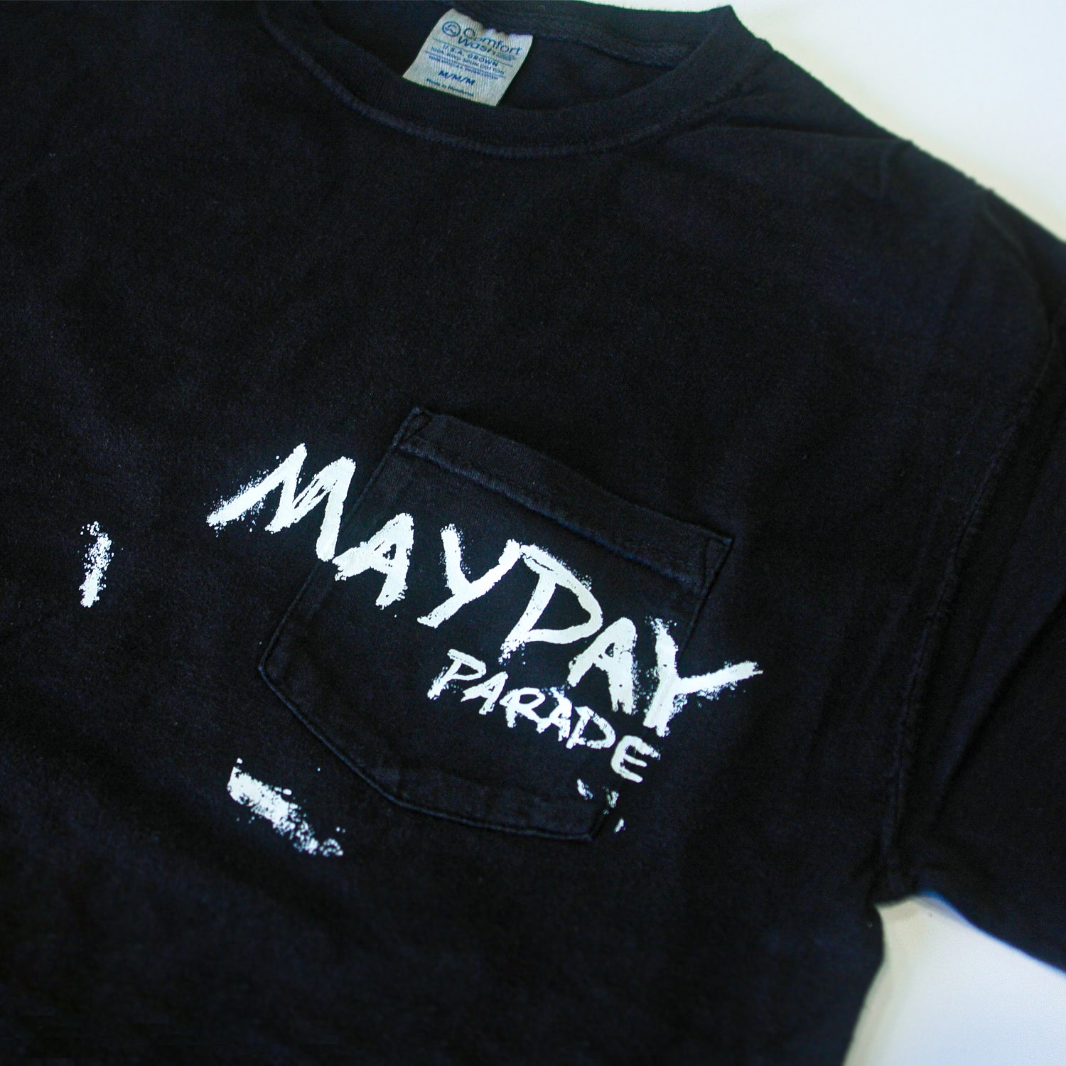 A black Mayday Parade ComfortWash Pocket T-Shirt with the band name in bold, white, distressed lettering across the chest pocket.