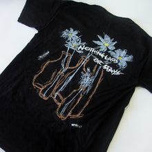 Load image into Gallery viewer, A black Mayday Parade Pocket T-Shirt featuring three hand-drawn vases with white flowers and the phrase “NOTHING LASTS OR STAYS” printed across the back.
