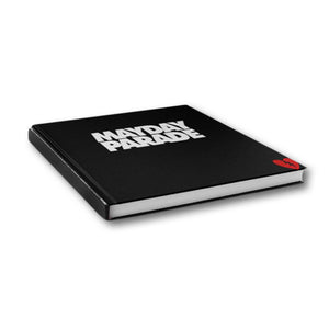 image of a black book laid on a white background. front of book says mayday parade in white and has a small, red broken heart on the bottom right corner