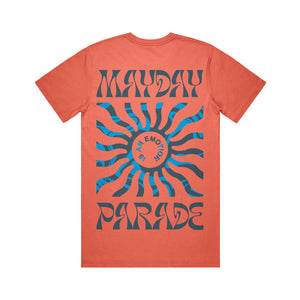 image of the back of a salmon colored tee shirt on a white background. tee has a full body print. at the top says mayday and the bottom says parade. in the center is a blue sun shape and inside says is an emotion.
