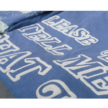 Load image into Gallery viewer, close up shot of the puff printing on the back of a blue tee shirt.
