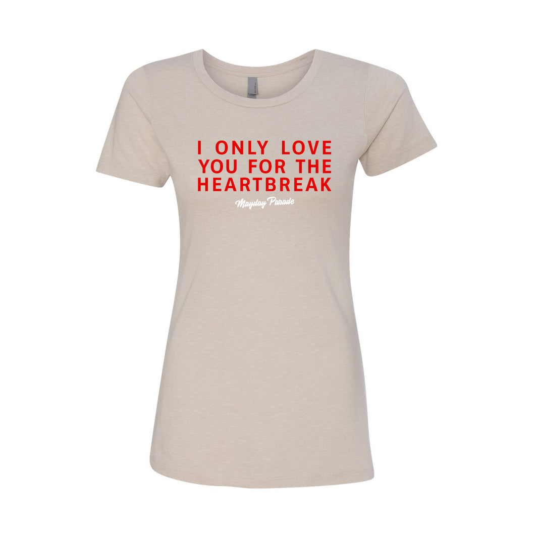 image of a women's sand colored tee shirt on a white background. red text across the chest that says i only love you for the heartbreak, with white cursive text below that says mayday parade