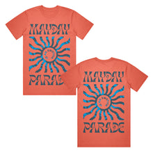 Load image into Gallery viewer, image of the front and back of a salmon colored tee shirt on a white background. front of tee is on the left and has a full body print. at the top says mayday and the bottom says parade. in the center is a blue sun shape and inside says is an emotion. the back of the tee is on the right and has the same print as the front of the tee.
